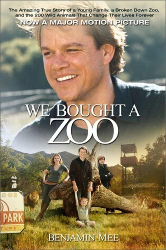 Movie poster for "We Bought a Zoo: The Amazing True Story of a Young Family, a Broken Down Zoo, and the 200 Wild Animals that Changed Their Lives Forever" featuring a smiling man, Benjamin Mee, in the foreground with a family of animals and a zoo entrance in the background. Text includes the title by Benjamin Mee (Author).
